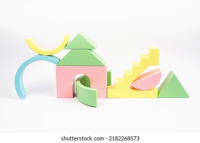Abstract composition of wooden figures. Figures of yellow pink, blue and green. The wooden children's cubes is isolated on a white background. Zero waste toy. - Powered by Shutterstock