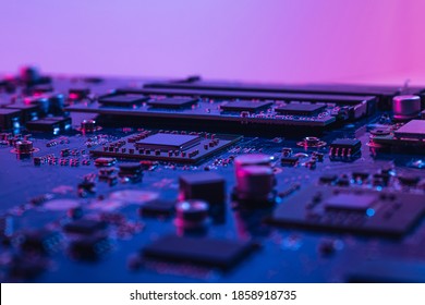 Abstract Computer Background With Electronic Device, Neon Colors Toned. Macro Photography Of Electronic Components. Microchip, CPU, Process, SMD Transistors.