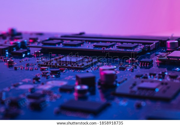 Abstract computer background\
with electronic device, neon colors toned. Macro photography of\
electronic components. Microchip, CPU, process, SMD\
transistors.