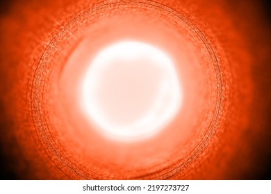 Abstract concentric background pattern in bright orange color with a sun halo in the center. Selective focus - Powered by Shutterstock