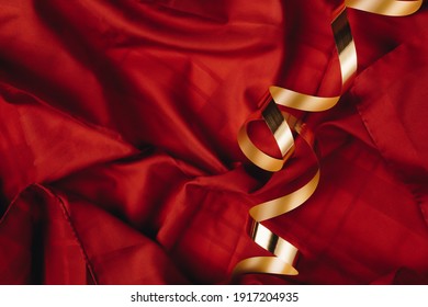 Abstract concept art of red silk or saten background with golden ribbon. Party or birthday idea with copy space. - Shutterstock ID 1917204935