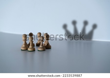 abstract concept, chess pawns make a shadow of queen or king crown 