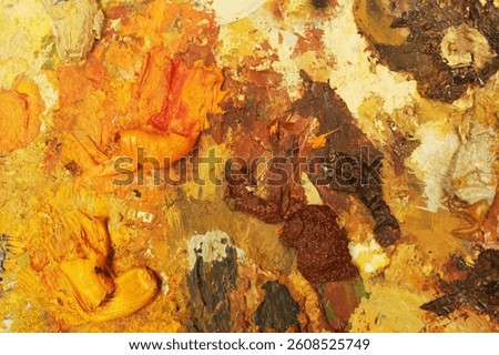 Abstract concept with multicolor background in red, orange, yellow. Board with paint stains as background texture.