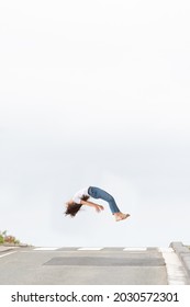 Abstract Concept Of Pedestrian Death By Car Crash Or Traffic Accident. The Soul Or Spirit Of A Woman Levitating To The Sky On The Road. Minimal Composition With Copy Space.