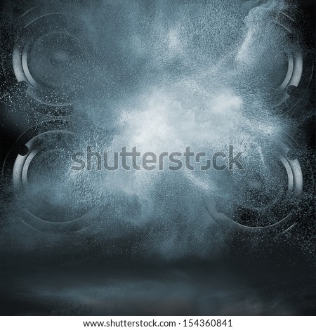 Abstract concept of powerful audio speakers blast out a cloud of dust against dark background