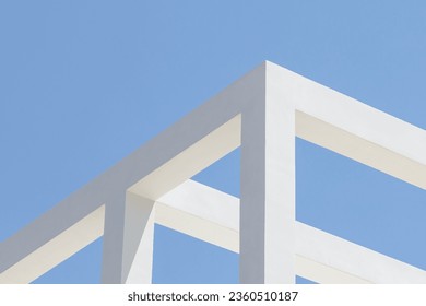 abstract concrete architecture detail. Geometric fragment of a modern structure building. white beams against a light blue sky. minimal design. contemporay and minimalist photography