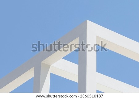 abstract concrete architecture detail. Geometric fragment of a modern structure building. white beams against a light blue sky. minimal design. contemporay and minimalist photography. angular. empty