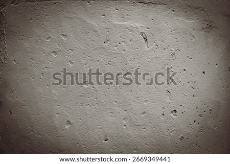 abstract concrete or plaster surface wall with uneven divots and pits. dramatic texture background with copy space