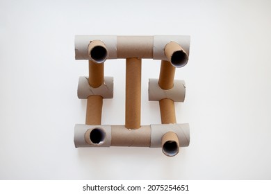 Abstract Construction Designed With Beige Carton Paper Tubes Isolated On White Background From A High Angle View