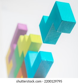 Abstract construction from wooden blocks. Colorful wooden building blocks. The concept of logical thinking.	 - Shutterstock ID 2200129795
