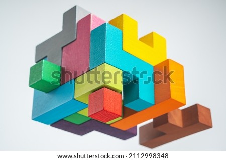 Abstract construction from wooden blocks. Colorful wooden building blocks. The concept of logical thinking.	