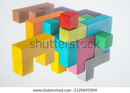 Abstract construction from wooden blocks. Colorful wooden building blocks. The concept of logical thinking.	