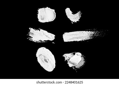Abstract cream stroke of white paint. Raw thick white color dye imprint. Isolated on black background.