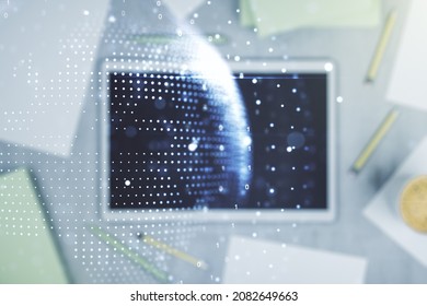 Abstract creative digital world map and modern digital tablet on desktop on background, top view, globalization concept. Multiexposure