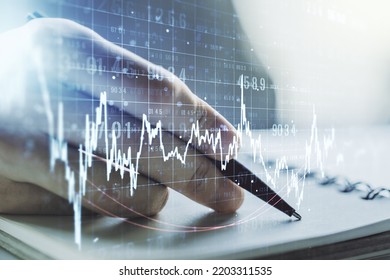 Abstract creative financial graph with hand writing in diary on background, financial and trading concept. Multiexposure