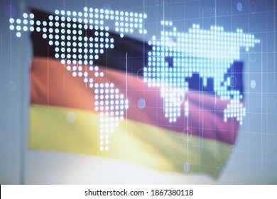 Abstract creative world map interface on flag of Germany and sunset sky background, international trading concept. Multiexposure