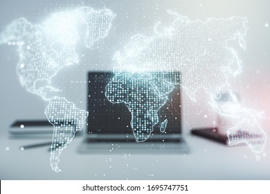 Abstract creative world map on modern laptop background, international trading concept. Multiexposure