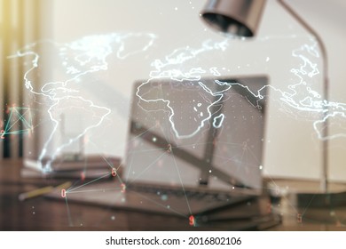 Abstract creative world map on modern laptop background, international trading concept. Multiexposure