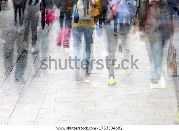 Abstract crowd\
of walking people while shopping in the pedestrian zone, multiple\
exposure, copy space. motion\
blur
