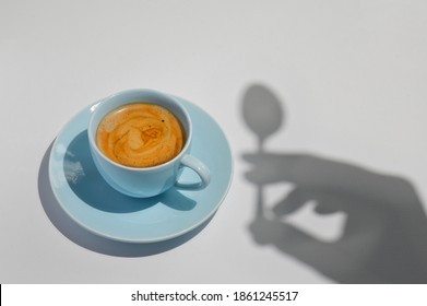 Abstract Cup Of Coffee with a Spoon and Hand Silhouette