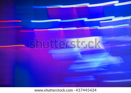 Abstract dancing people motion blur effect in concert Theater, photographed with long exposure an moving camera.