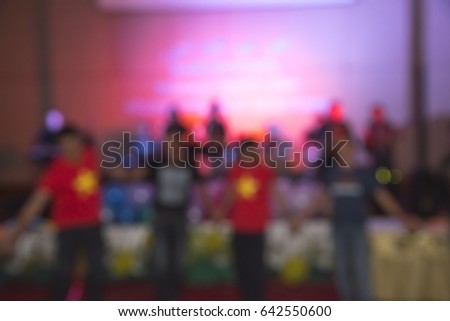 Abstract dancing people motion blur effect in concert 