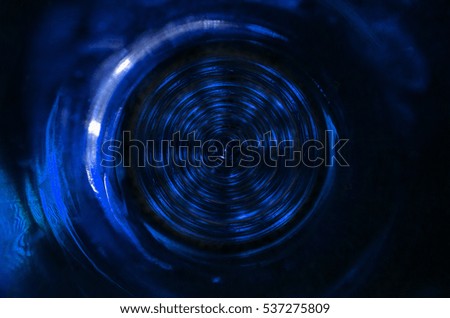 Abstract dark blue colored technical background or glass eye or round disc, spiral or fractal background with crossing circles and ovals. disco lights background.