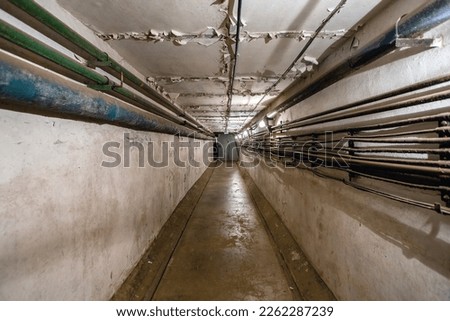 Abstract dark corridor of military bunker interior, grungy old underground tunnel. Nuclear shelter