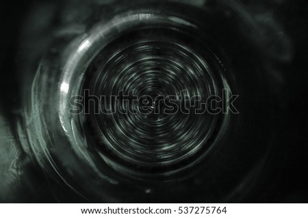Abstract dark grey colored technical background or glass eye or round disc, spiral or fractal background with crossing circles and ovals. disco lights background.