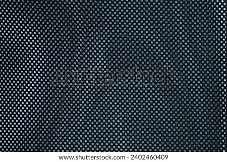 Abstract Dark Gridiron Macro Texture. Abstract black grid texture on metal with detailed typeface.