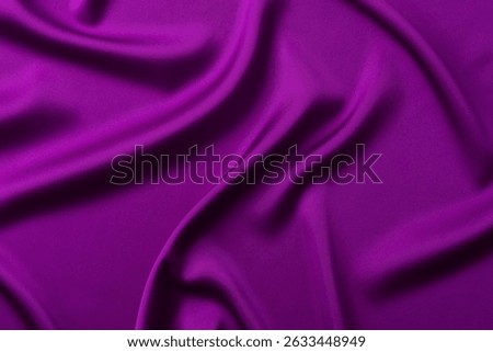 Abstract dark purple background. Deep violet silk satin fabric with soft wavy folds. Elegant background with space for text. Anniversary, award concept