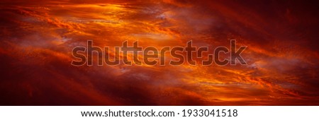 Abstract dark red background. Dramatic fiery bloody sky. Fantastic golden sunset background with copy space for design. Halloween, evil, armageddon, apocalypse concept. Wide banner. Panorama. Nobody.