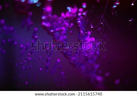 ABSTRACT DARK SCIENTIFIC BACKGROUND WITH MICROSCOPIC ELEMENTS IN SUBSTANCE, LABORATORY RESEARCH BACKDROP