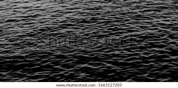 Abstract Dark Water\
Surface.Waterfall wave water background texture. Balck and white\
background. black water sea wave. water reflection texture\
background. Black Sea\
Waves