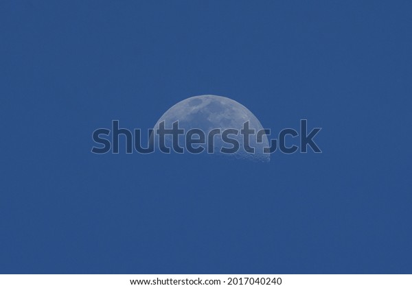 abstract daytime
half moon in the sky
background