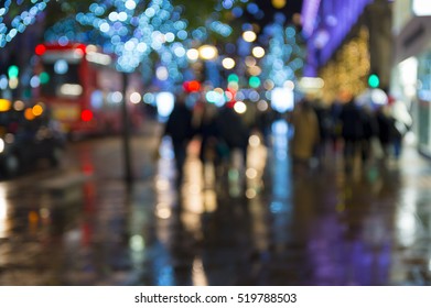 Abstract Defocus Night View Of Holiday Lights And Christmas Shopping Crowds On A Wet Night On Oxford Street, In London, UK