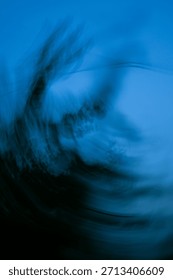 Abstract defocused backplate features deep blues, shadowy gradients, and glowing bokeh orbs.