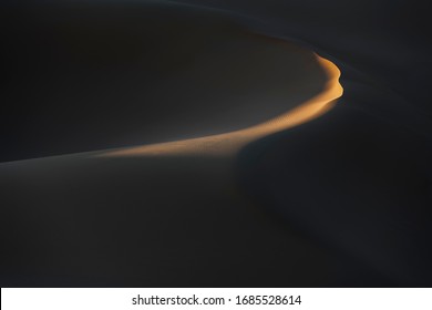 Abstract desert sand dunes with deep shadows and early morning light. Erg Chagaga, Mhamid, Morocco. - Powered by Shutterstock