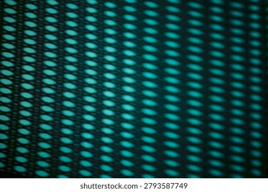 Abstract design featuring light and shadow patterns from a perforated metal surface, with teal and black colors creating a rhythmic visual effect