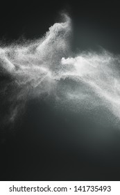 Abstract Design Of White Powder Cloud Against Dark Background