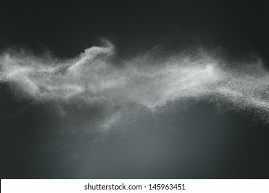 Abstract Design Of White Powder Cloud Against Dark Background