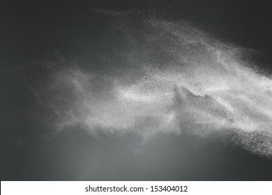 Abstract Design Of White Powder Cloud Against Dark Background