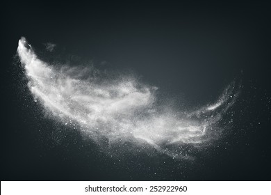 Abstract Design Of White Powder Cloud Against Dark Background