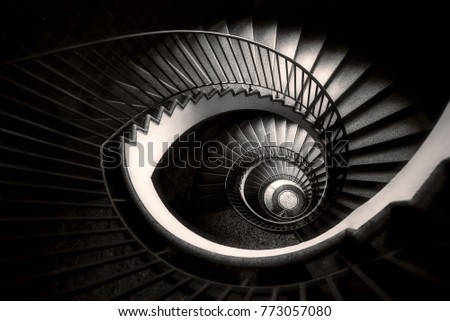 an abstract detail of a spiral staircase in an old building, black and white, monochromatic