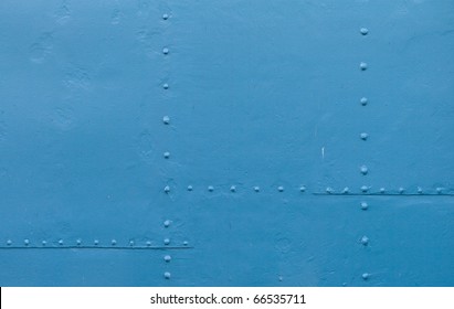 Abstract detailed blue metal wall background texture with seams and rivets