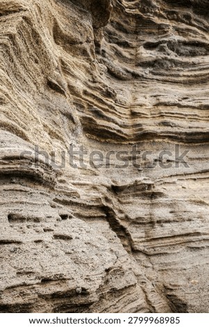 Abstract diagonal pattern of fine sedimentary rock layers and striations revealed by natural coastal erosion on Jeju