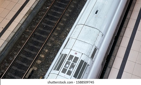 Abstract Diagonal View Of Train Tracks And Platform With High Speed Train Engine Taken From Above Or Aerial View.                               