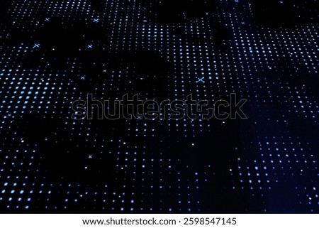 Abstract digital pattern with blue lights. Dotted blue light grid on black. Abstract technology background with blue dots. Dark surface with light points. Digital grid with blue illumination
