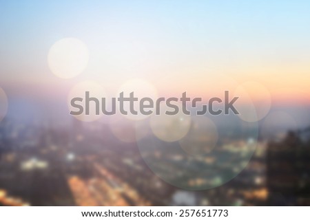 abstract double exposure of blurred sky night city downtown construction with circle round light background with lens flare effect concept.