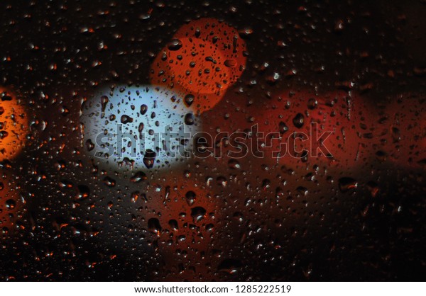Abstract droplets, Wet window, light bokeh on\
glass at night, background\
texture